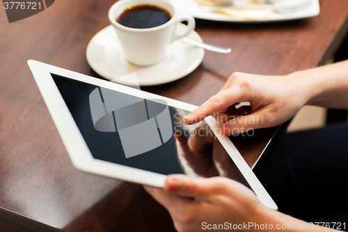 Image of close up of woman with tablet pc and coffee