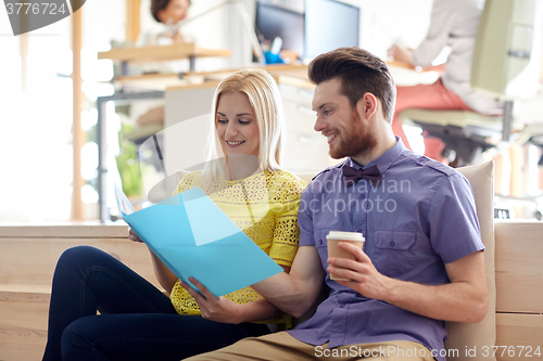 Image of office workers with folder and coffee