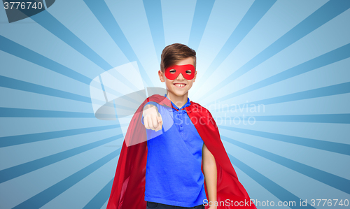 Image of happy boy in red superhero cape and mask