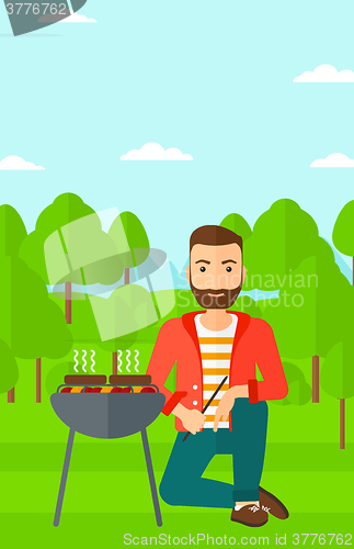 Image of Man preparing barbecue.