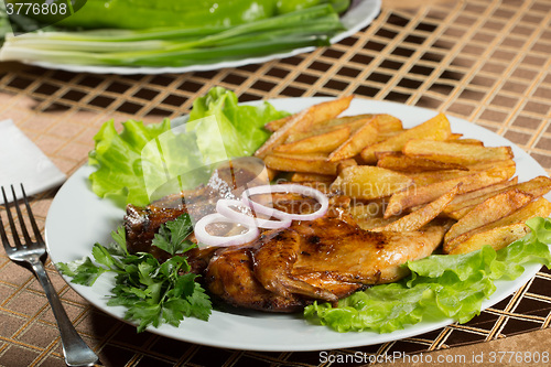 Image of Tobacco chickens with fried potatoes. 