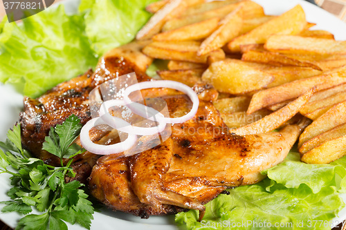 Image of Tobacco chickens with fried potatoes. 