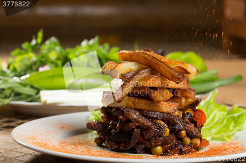 Image of fried potatoes with meat. 