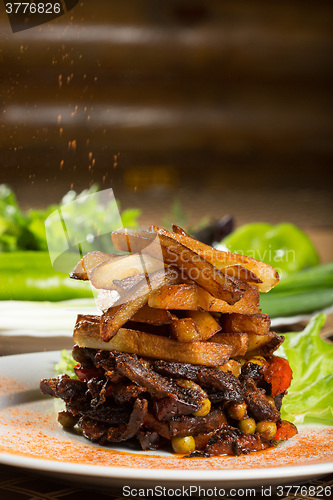 Image of fried potatoes with meat. 
