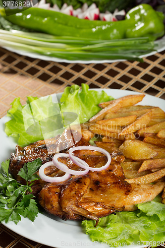 Image of Tobacco chickens with fried potatoes. 