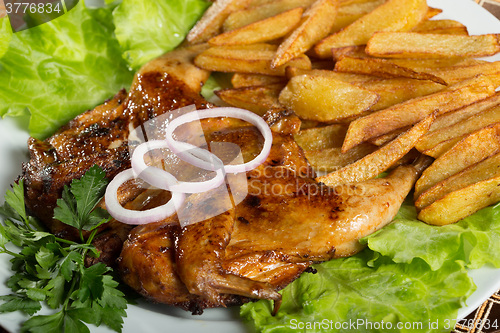 Image of Tobacco chickens with fried potatoes. 