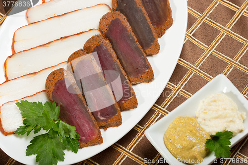 Image of Cutted meat and lard on a plate