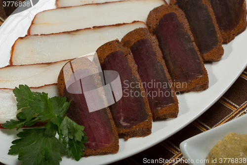 Image of Cutted meat and lard on a plate