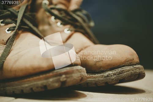 Image of Old and Dirty boots in mud