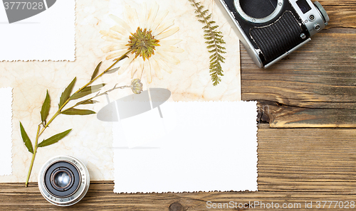 Image of still life with copy space photo, lens, retro camera and pressed