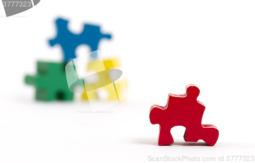 Image of Closeup of big jigsaw puzzle piece, perspective