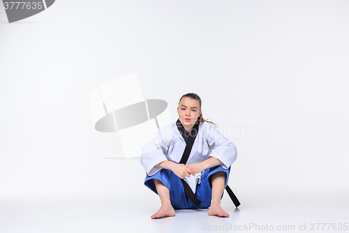 Image of The karate girl with black belt 