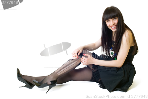 Image of Young smiling woman in torn stockings
