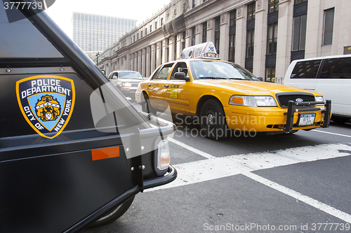 Image of Yellow taxi and Nypd vehicle in Manhattan