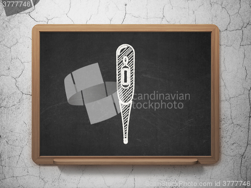 Image of Health concept: Thermometer on chalkboard background