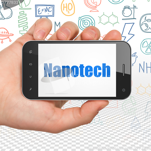 Image of Science concept: Hand Holding Smartphone with Nanotech on display