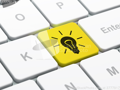 Image of Business concept: Light Bulb on computer keyboard background