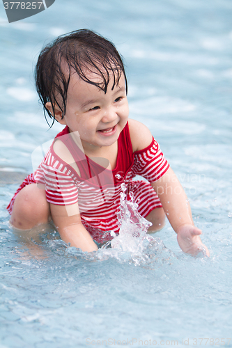 Image of Chinese Little Girl Playing in Water