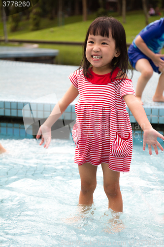 Image of Chinese Little Girl Playing in Water