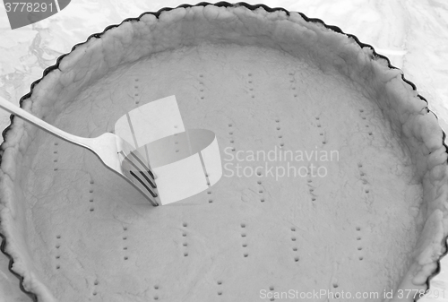 Image of Fork making holes in a raw pastry case