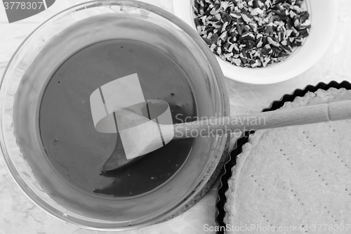 Image of Making pecan pie - stirring the filling with a wooden spoon