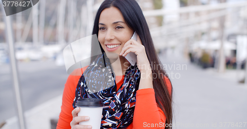 Image of Fashionable young woman listening to a call
