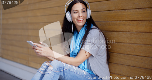 Image of Attractive young woman listening to her music