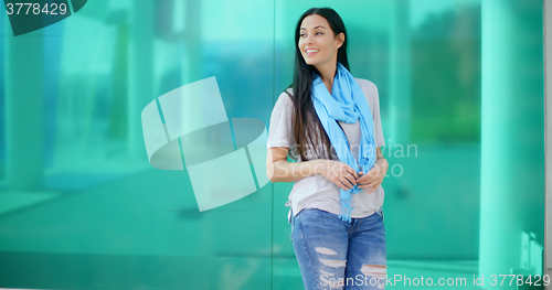 Image of Happy woman looking sideways in front of glass