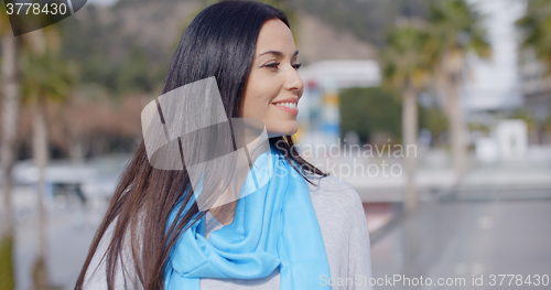 Image of Smiling vivacious young woman in an urban street