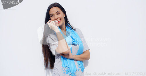 Image of Attractive young woman talking on a mobile