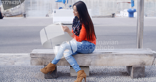 Image of Relaxed confident young woman on a mobile
