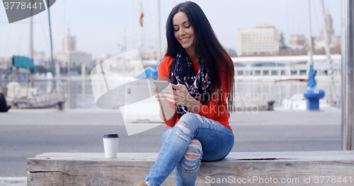 Image of Relaxed confident young woman on a mobile