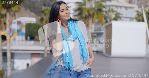 Image of Gorgeous woman putting hand through hair