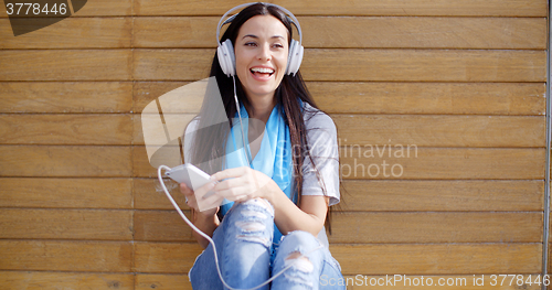 Image of Happy woman enjoying her music