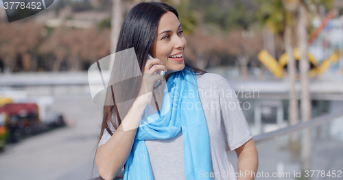 Image of Enthusiastic female using phone outdoors