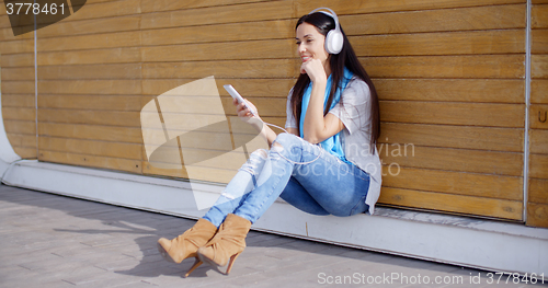 Image of Attractive young woman listening to her music