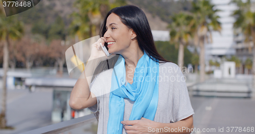 Image of Enthusiastic female using phone outdoors