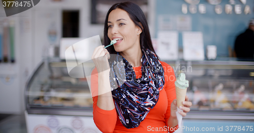 Image of Attractive stylish young woman in a delicatessen