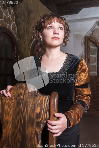 Image of Pretty woman an armchair and with wine glass