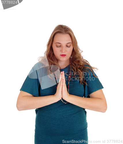 Image of Praying woman with hands folded.