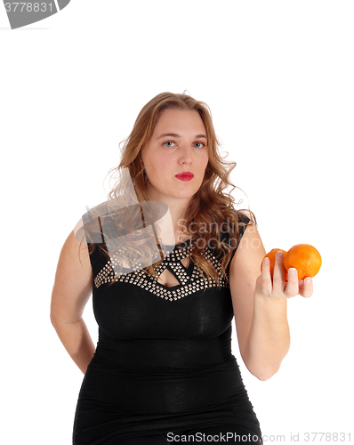 Image of Blond woman holding two oranges.