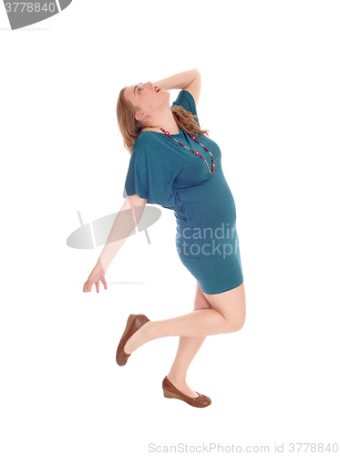 Image of Woman in green dress dancing.