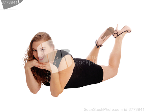 Image of Woman lying on floor and smiling.