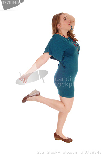 Image of Woman dancing is dress.