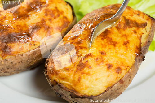 Image of baked potatoes whole in their skins 