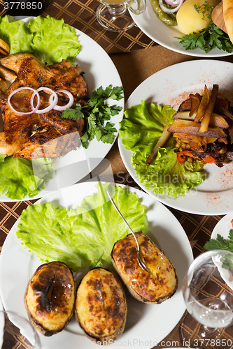 Image of table with normal food, steaks and potatoes. 