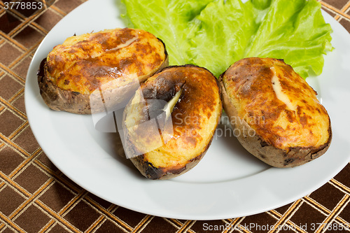 Image of baked potatoes whole in their skins 