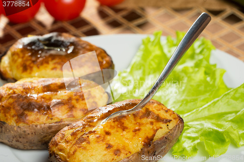 Image of baked potatoes whole in their skins 