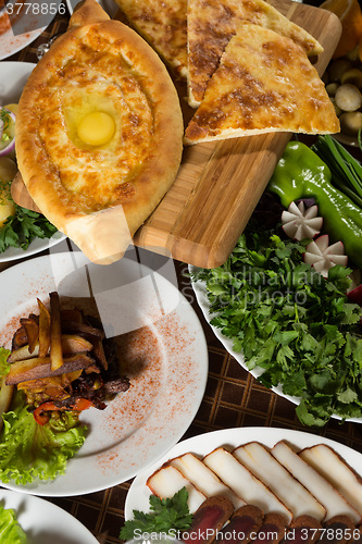 Image of table with normal food, steaks and potatoes. 