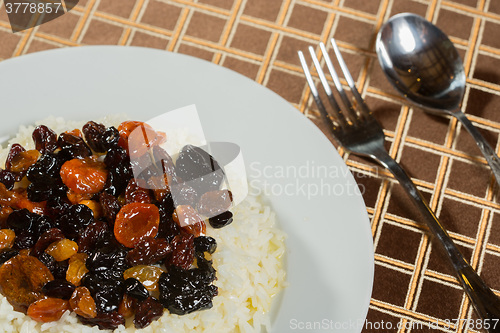 Image of Vegetarian sweet rice with dried apricots and raisins close-up on the table. 